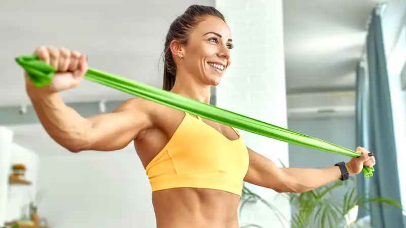 According to a Pilates instructor, this standing resistance band workout can work all major muscle groups in 25 minutes