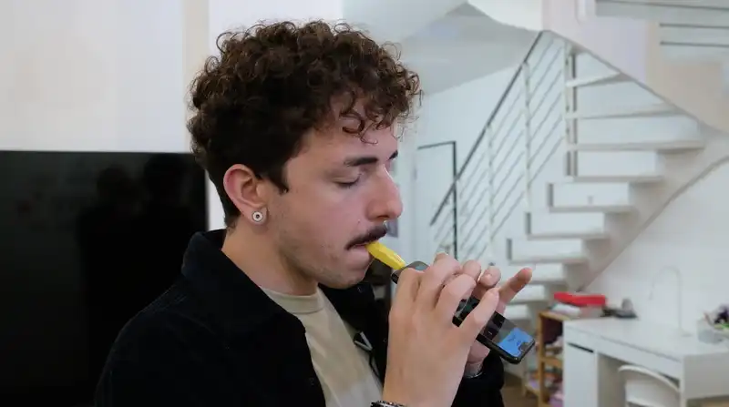 A kazoo-like attachment turns the smartphone into a musical instrument.